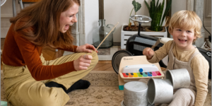 little boy and his mômji nanny play with musical instruments